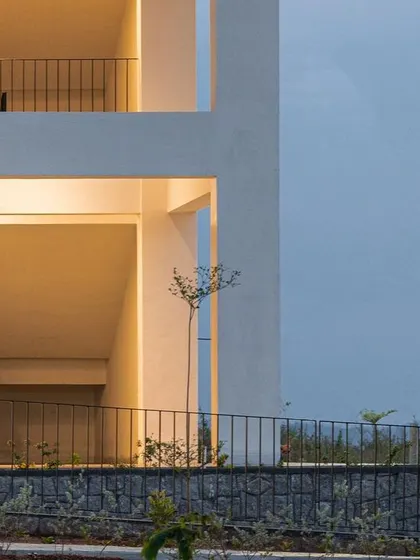 A detail of the factory workers' housing, showing the open stairwells and balconies. These semi-open spaces are designed to encourage social interaction and provide residents with a connection to the outdoors, improving their quality of life.