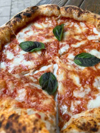 A close-up of our Margherita, sliced and ready to be shared.