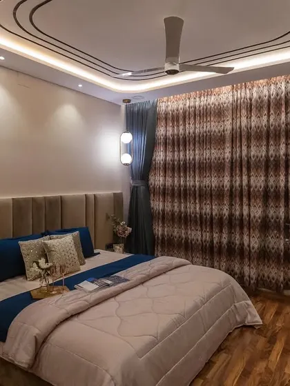 Another angle of the classic bedroom, showing the intricate design of the false ceiling and the combination of ambient and spot lighting.
