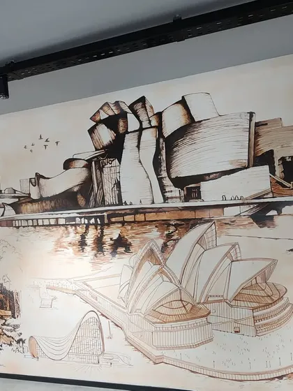 Another detailed shot of the architectural mural, highlighting the intricate sketches of famous global landmarks.