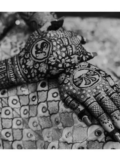 A detailed black and white shot of the bride's completed mehndi, showcasing the beautiful and complex patterns.