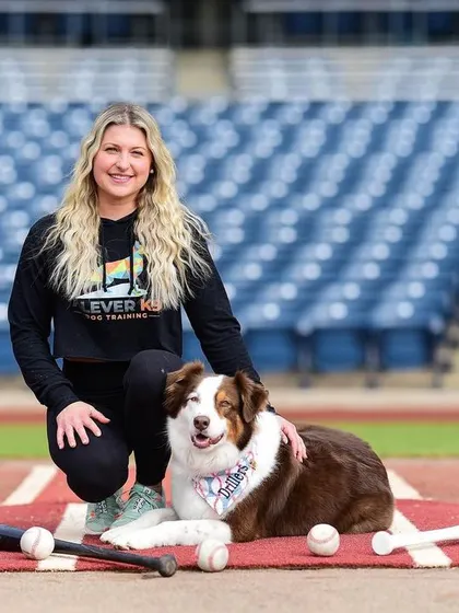 Me and my Australian Shepherd, Mia, on the field at a Tulsa Drillers game. She's a natural performer and loves her job as a bat dog.