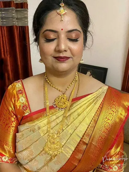 A close-up showing the soft, bronze eye makeup and deep red lip. This combination is perfect for traditional events, providing a touch of color without being overpowering.