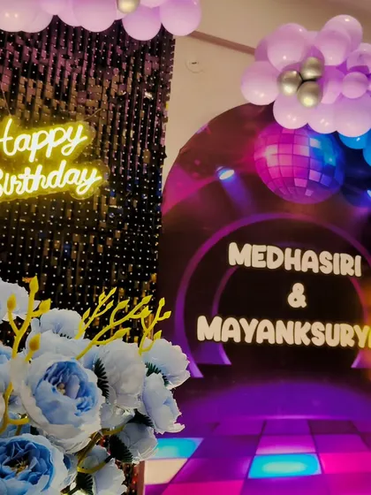 A "Rock stars turning TWO" party with a disco theme. The decor features a dance floor backdrop, a disco ball graphic, and a neon sign for a fun and energetic vibe.