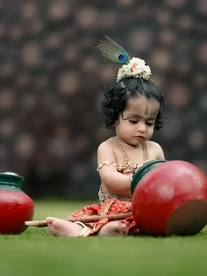 A little Krishna playing with pots of 'butter' in our garden. A beautiful outdoor setting for a traditional theme.