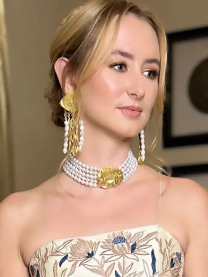 A close-up of the client's makeup, featuring soft, neutral tones and highlighted skin that gives her a radiant glow. The look is perfect for a day wedding.