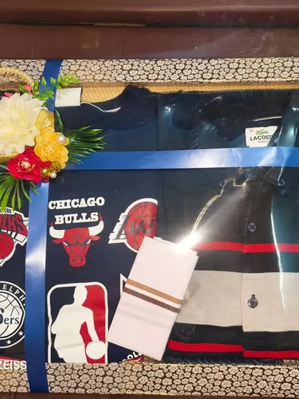 For the sports fan groom, this hamper includes a Chicago Bulls t-shirt and other casual wear. I can customize the packing to match the groom's interests.
