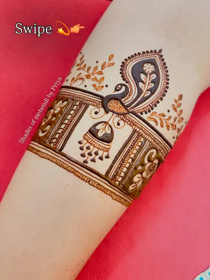 The top band of the arm design, featuring a peacock and jhumka. This shows how I build up a full-arm mehendi with different beautiful elements.