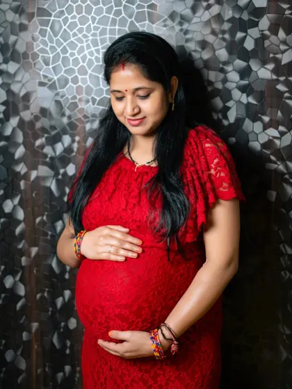 The beautiful glow of motherhood. This is a classic portrait from a studio maternity session, focusing on the pure love and anticipation for the new arrival.