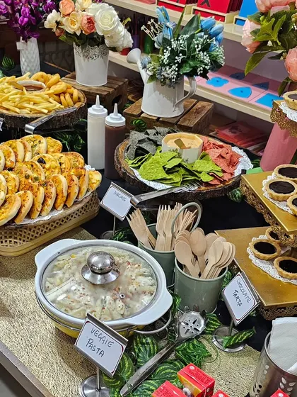 Another angle of our birthday grazing table, showing the thoughtful arrangement of veggie pasta, chocolate tarts, mini pizzas, and fries with dipping sauces.