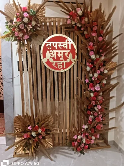A rustic yet elegant backdrop for a home-based Tapasvi ceremony. I used a wooden slat screen, arches of pink roses and dried pampas grass, and a custom red sign.
