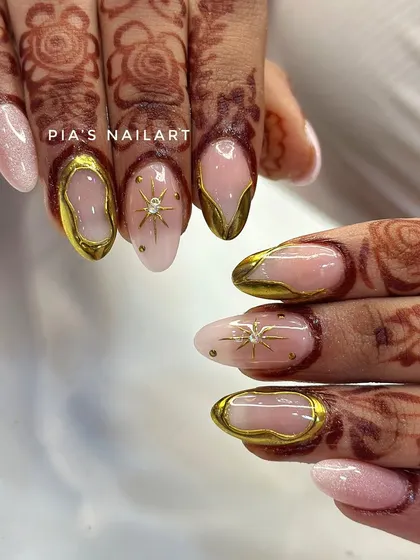 Your bridal look deserves nails that are just as special. Here, I've combined a soft, milky base with stunning 3D gold chrome frames and delicate starburst details, designed to perfectly complement traditional henna.