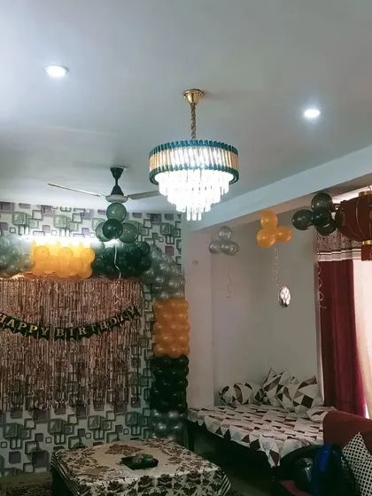 A view of a simple home decor setup. Even with just balloons and a "Happy Birthday" banner, a room can be transformed.