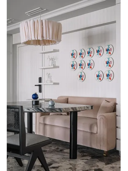 A close-up of the dining nook, showing the playful art and comfortable banquette seating.
