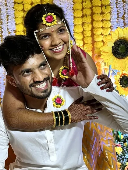 Capturing a fun moment between the couple against the bright and cheerful sunflower and marigold backdrop of their Haldi function.