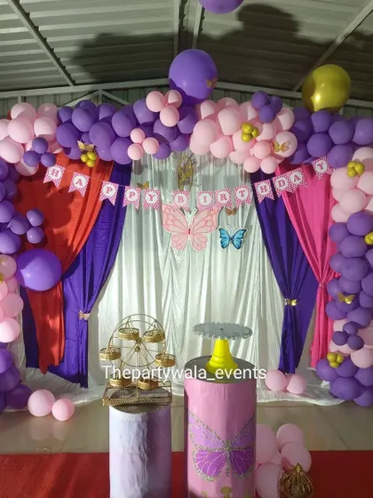 A butterfly theme with a stage curtain backdrop in purple and pink.