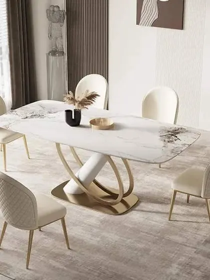 Another view of this stunning dining table, showcasing the elegant curve of the base and the subtle patterns in the marble top.