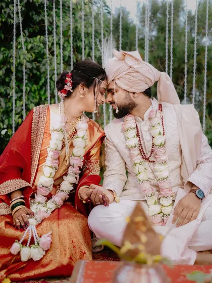 An intimate, seated portrait of the couple, their heads together in a moment of quiet connection.