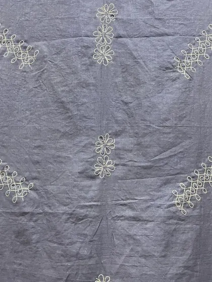 A different angle of the Sashiko-embroidered saree, highlighting the texture of the cotton fabric and the delicate white threadwork.