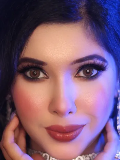 Another angle on a dramatic eye makeup look, this time under cool-toned lighting. You can see how the bold blush and deep red lip balance the intense eyes, perfect for a photoshoot or a bold event look.