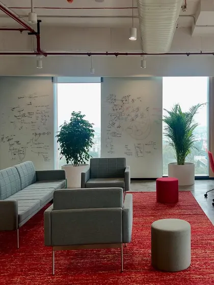 This lounge area in the Netenrich Bangalore office combines comfort with function, featuring writeable wall surfaces for brainstorming. The space is designed to be fresh, vibrant, and low-maintenance, a meaningful workplace for a cutting-edge internet security company.