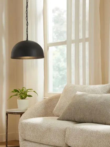 A living room scene featuring a modern dome pendant light. This image shows how lighting fixtures can be integrated into a space to create mood and style.
