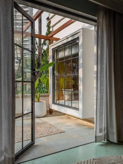 A view from the kids' suite out to the terrace at Summer Haus. The design emphasizes the connection between indoor and outdoor spaces, a key element of our architectural approach.