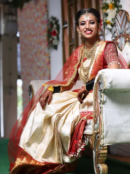 A full-length view of the complete bridal attire. The makeup, hair, and saree draping all come together to create a majestic look for the bride.