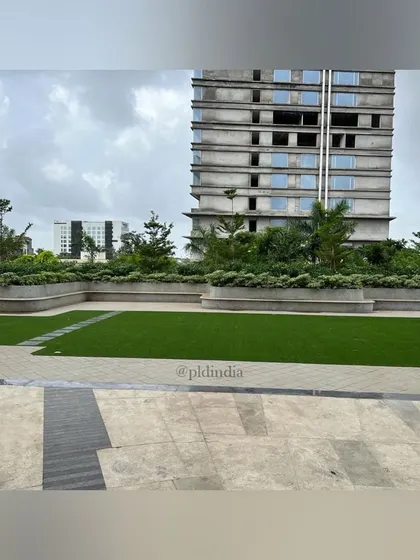This image shows the scale of the landscaping against a backdrop of commercial buildings, one of which is under construction. My work often involves planning green spaces for new developments, ensuring nature is integrated from the project's inception.