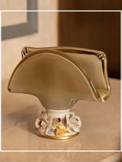 Add a touch of timeless elegance to your space with this Murano Collection piece. The unique, handkerchief-like shape of the bowl and its delicate floral base make it a stunning example of luxurious craftsmanship.