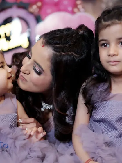 A candid moment of affection between a mother and her two daughters. These natural shots often become the most treasured memories from a family event.