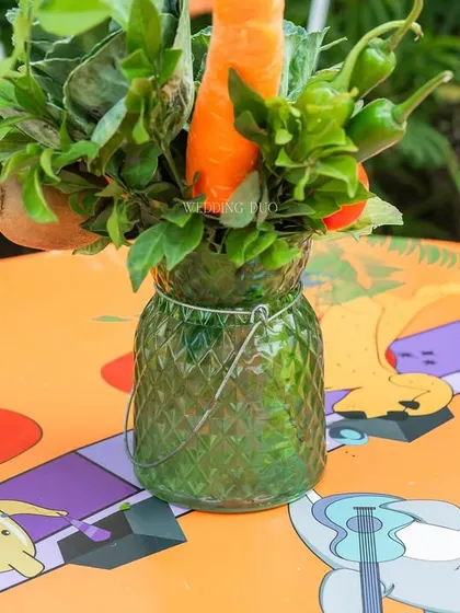 We believe in playful details. For this festival-themed Mehendi, we used fresh vegetables like carrots and chilies in our centerpieces, adding a quirky and sustainable touch to the colorful tables.