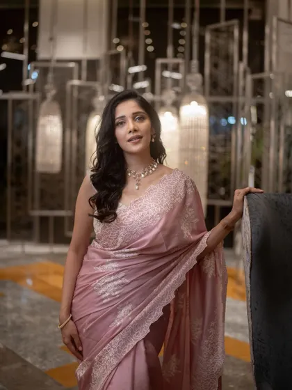 A timeless look for the lovely Milana Nagaraj. This pastel pink saree is paired with a custom-designed blouse featuring delicate white embroidery, creating an outfit that is both elegant and unforgettable.
