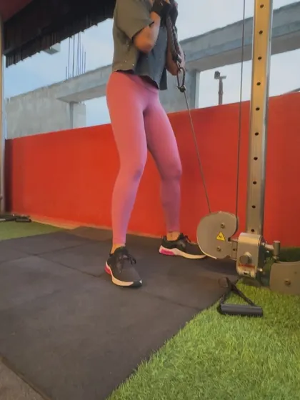 A client performs a cable crunch, isolating the abdominal muscles for a targeted core workout.