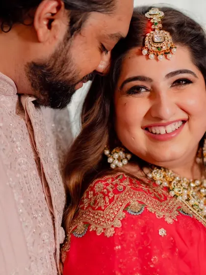 A candid moment between the happy couple. Her makeup was designed to look fresh and natural, focusing on glowing skin and softly defined eyes, perfect for these close-up, heartfelt shots.