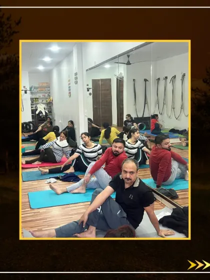 A large class enjoying the benefits of Vakrasana, which helps to release stress and back pain.