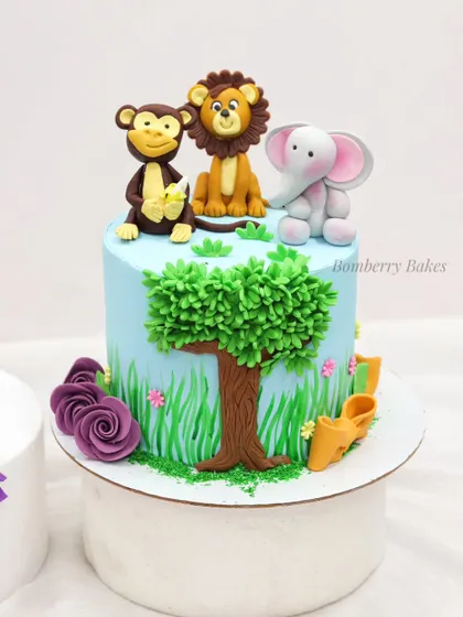 A close-up of the fondant animal toppers made in my beginner's class. You'll learn to model a cute monkey, lion, and elephant to sit atop your jungle-themed cake.