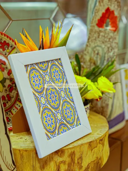 A small, framed piece of tile-inspired art adds a pop of color and personality to a "la dolce vita" themed birthday party. It's these little details that bring a theme to life.