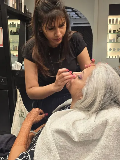 Another angle showing the careful application of makeup, ensuring a flawless and long-lasting finish for any event.