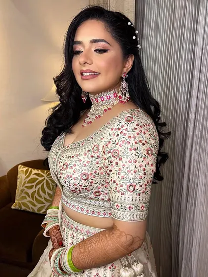 Another angle of this stunning engagement look. The soft waves in her hair, adorned with pearls, complete the elegant and confident vibe.