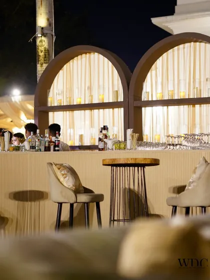 Sit, sip, and savor. Our custom-designed bar counter, with its elegant arched backdrop and warm lighting, ensures that every drink is served in style.
