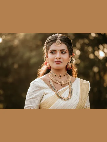 A beautiful, softly lit portrait of the bride, framed in a warm brown border.