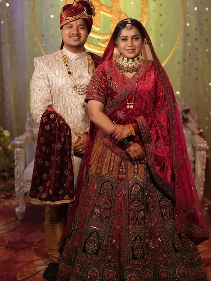 The complete royal look. This couple looks magnificent, with the bride in a heavy velvet lehenga and the groom in a coordinated embroidered sherwani.
