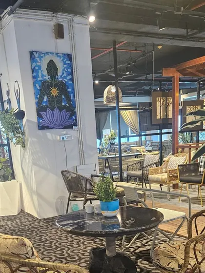 A glimpse into our eclectic showroom, where modern furniture pieces are displayed alongside vibrant art, creating an inspiring environment for our clients.