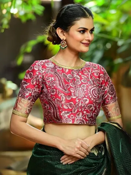 A red printed silk blouse, perfect for adding a touch of color and pattern to your ensemble.