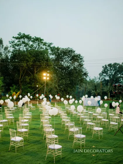 A field of dreams for a wedding ceremony. I arranged the guest seating on a lush green lawn, with each chair holding a white balloon, creating a simple yet whimsical and highly photographic setting.