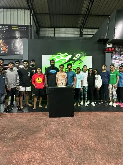 The team gathers for a photo inside our gym, a place where champions are made.