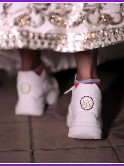 A close-up of the custom wedding sneakers with the couple's initials. A cool, comfortable, and personalized detail.