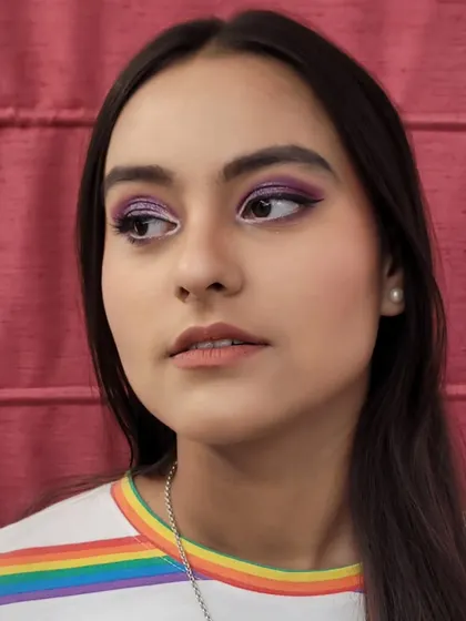 A side profile of the purple semi cut crease look. The defined crease and winged liner add dimension and a touch of drama.