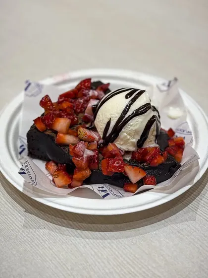Our gooey brownie topped with fresh strawberries and a scoop of vanilla ice cream. A perfect dessert to share.